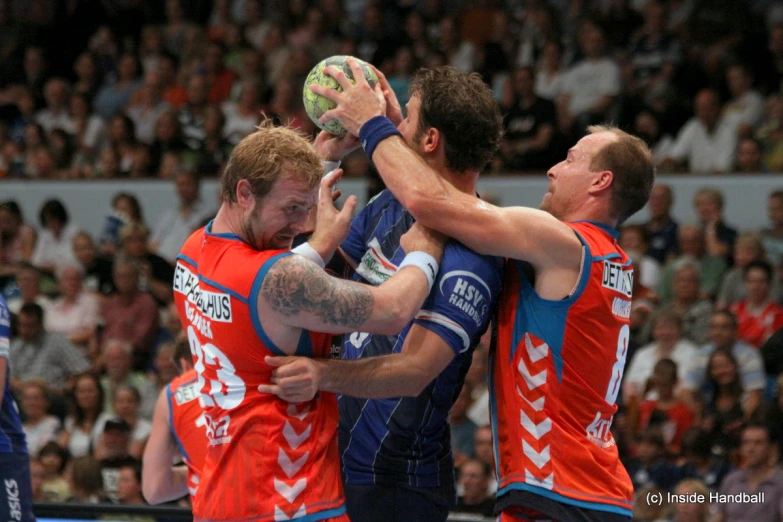 a group of men playing a game of basketball