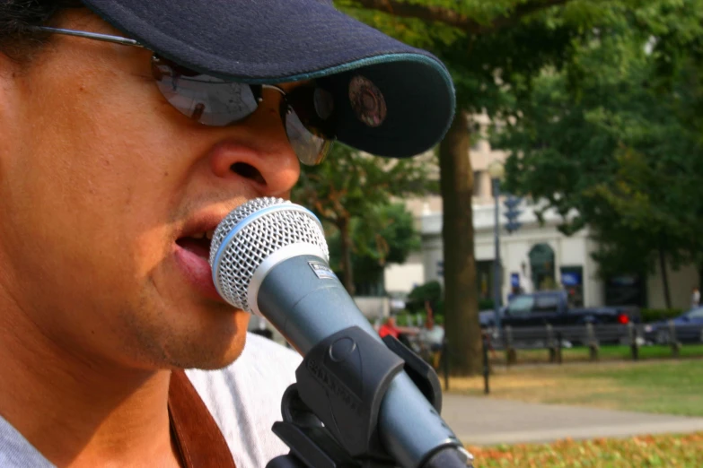 a man that is sitting in front of a microphone