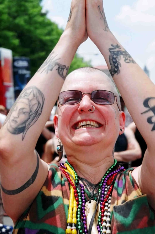 a woman with tattoo arms and legs covering the eyes