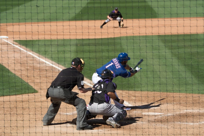 a baseball player holding a bat next to home plate