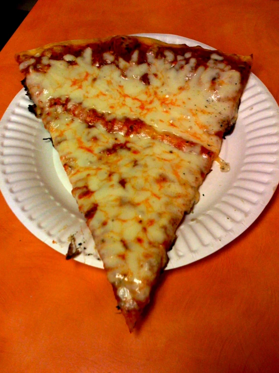 there is a white plate with a slice of cheese pizza on it