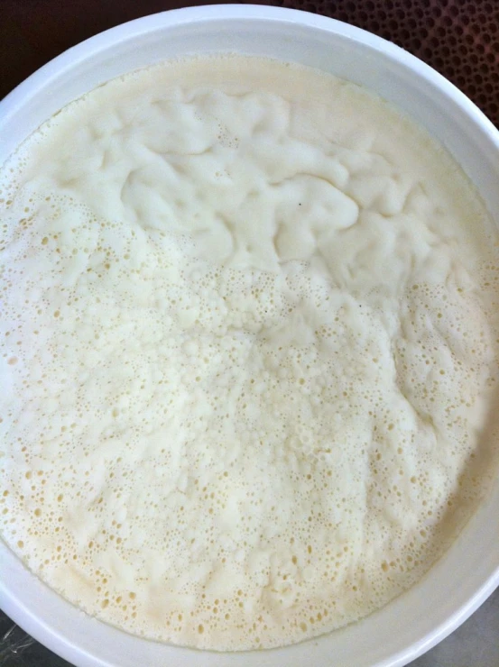 a white bowl containing a mixture of liquid