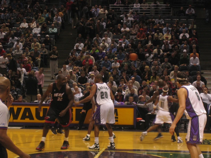 a group of men on a court with people in the stands