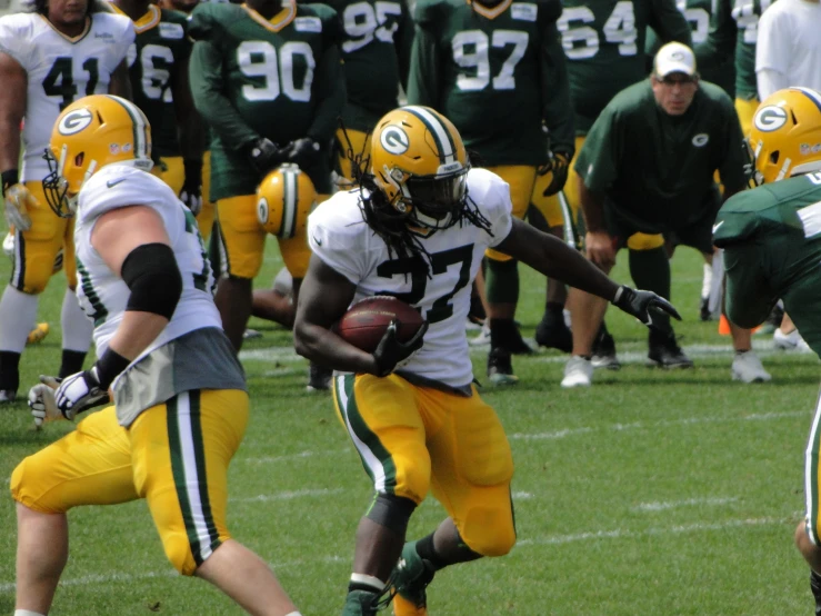 a football player holding a ball in his hands