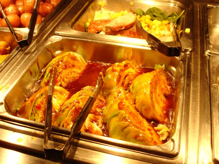 a silver plate topped with meat and a buffet