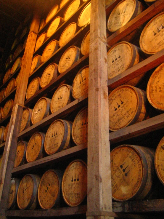 barrels stacked high on a rack in a cellar