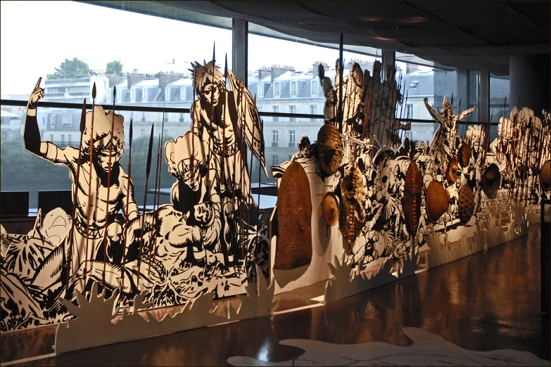 artwork with various pieces of paper hanging in front of a window