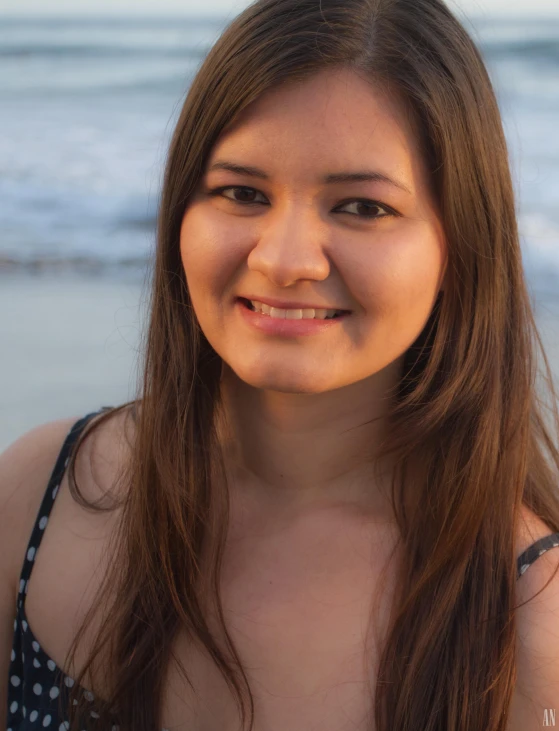 there is a woman on the beach posing for a po