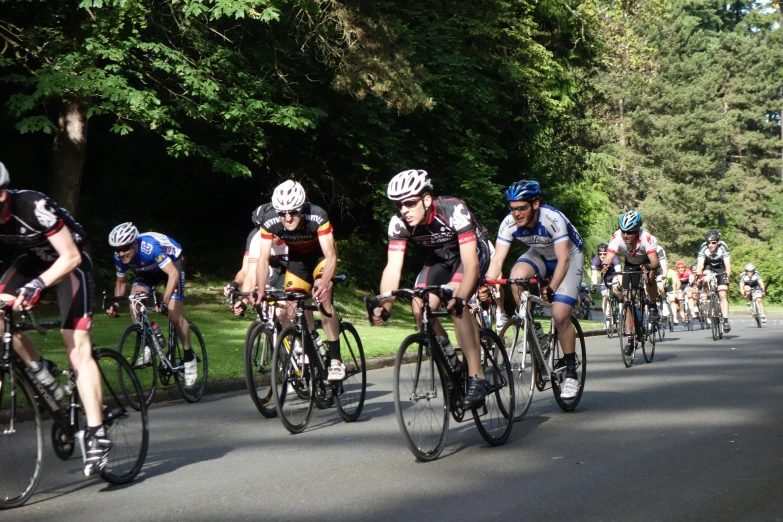 many bicyclists ride in a bike race down the street