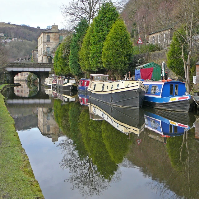 several boats are docked along the river side