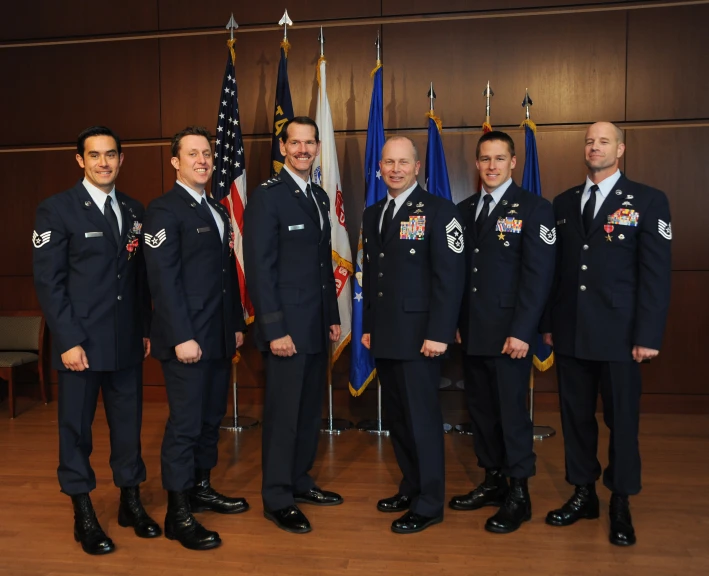 the six officers in uniform are posing for a po