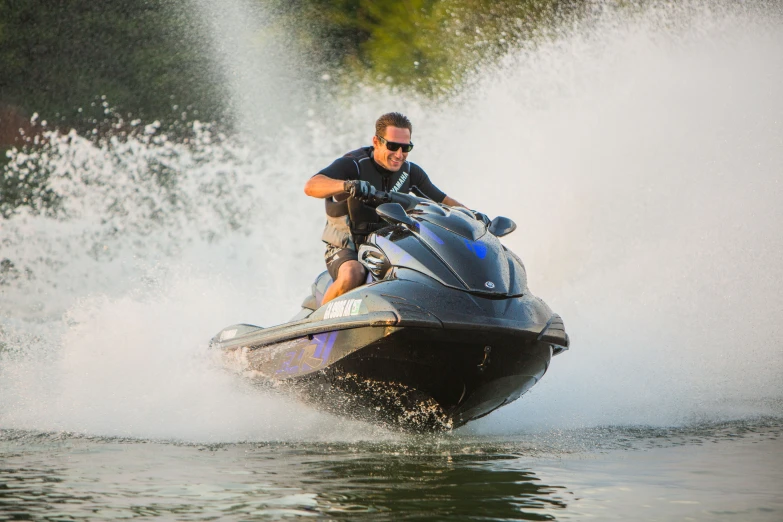 a man on a jet ski speeds through the water