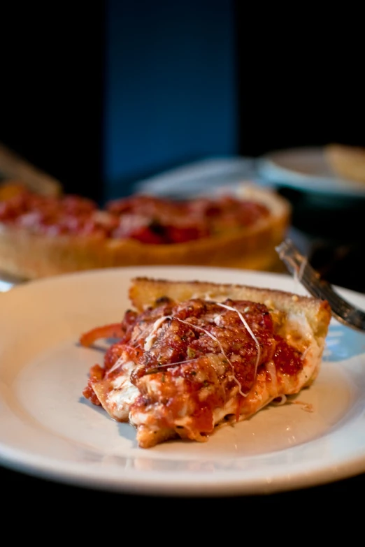 a slice of pizza on a white plate