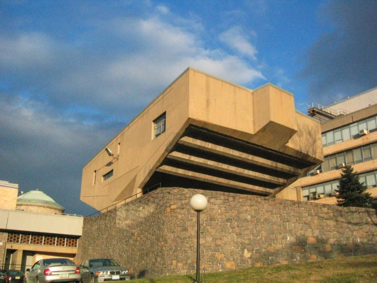 a large building with a stone wall near the top