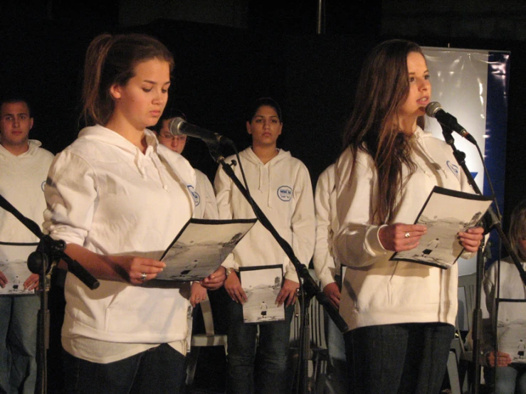 a group of people that are standing in front of microphones