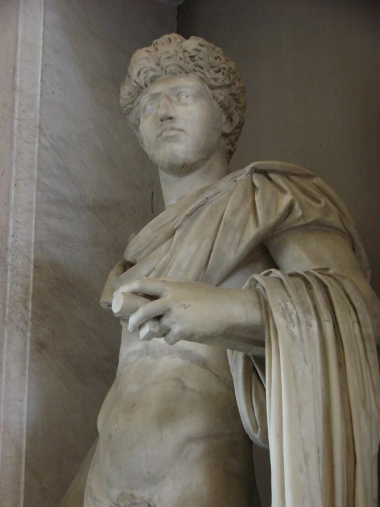 a close - up view of a statue showing his left hand on the right side of the body