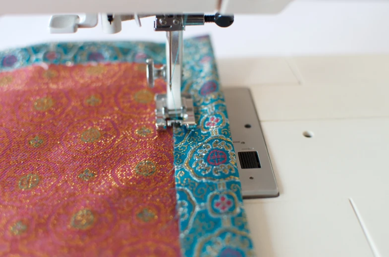 a fabric being sewn on to machine