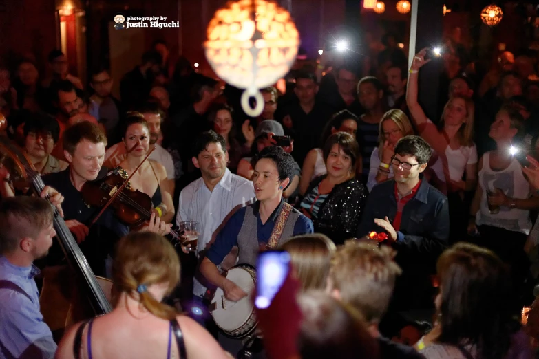 a large crowd of people watching a music event