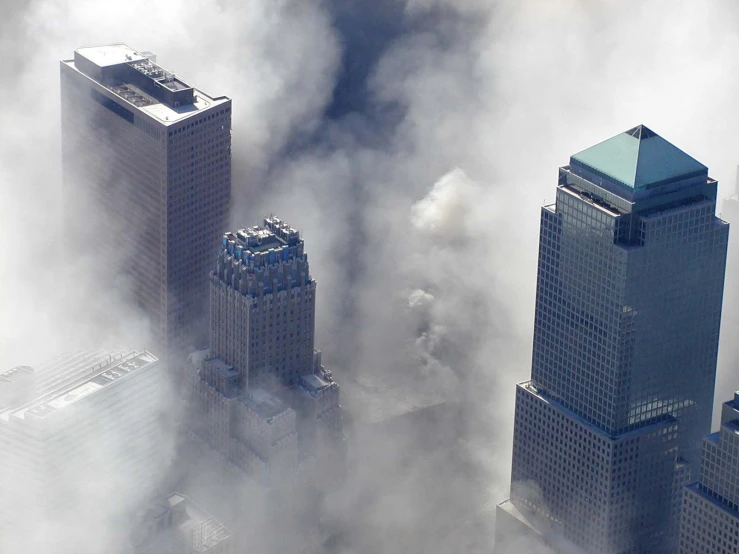 smoke billows from the clouds and a building