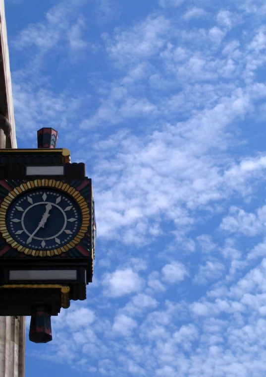 a large clock attached to a tall building