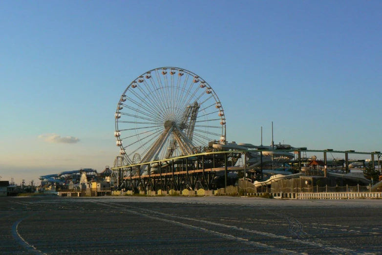 a carnival with a giant wheel in the background