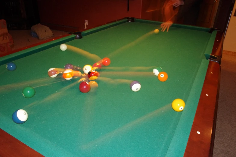 a pool table that has some balls on it