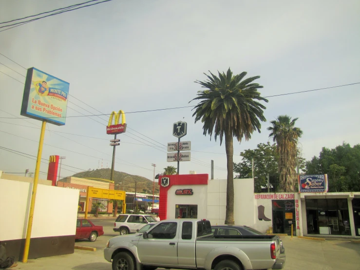 a truck is parked in front of a small fast food restaurant