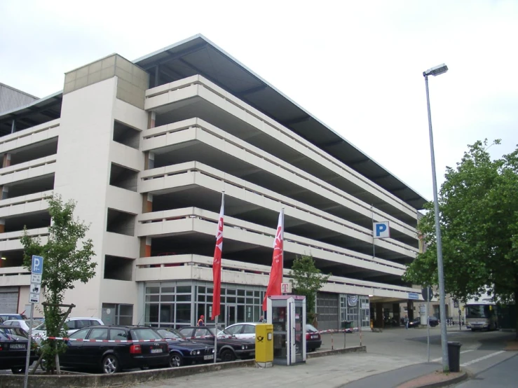 a parking garage that has cars parked at the entrance of it