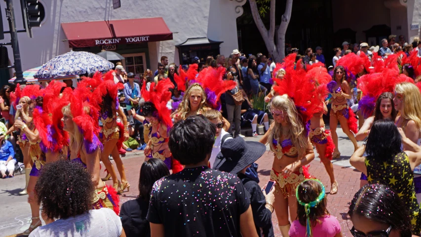 a large group of people with some wearing dresses and headpieces