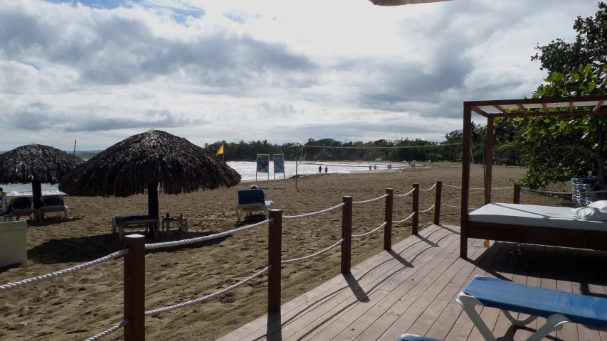 there is an empty beach with many sun lounge chairs