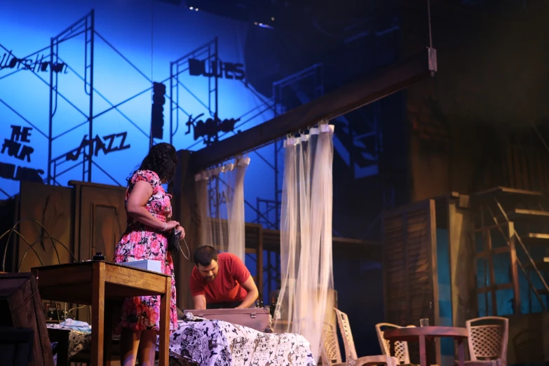 two women are sitting on the stage together