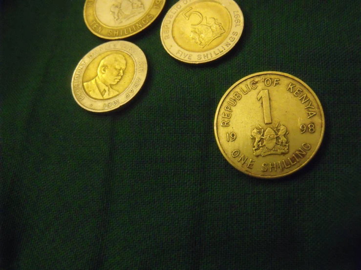 five gold coin with pictures of a soldier