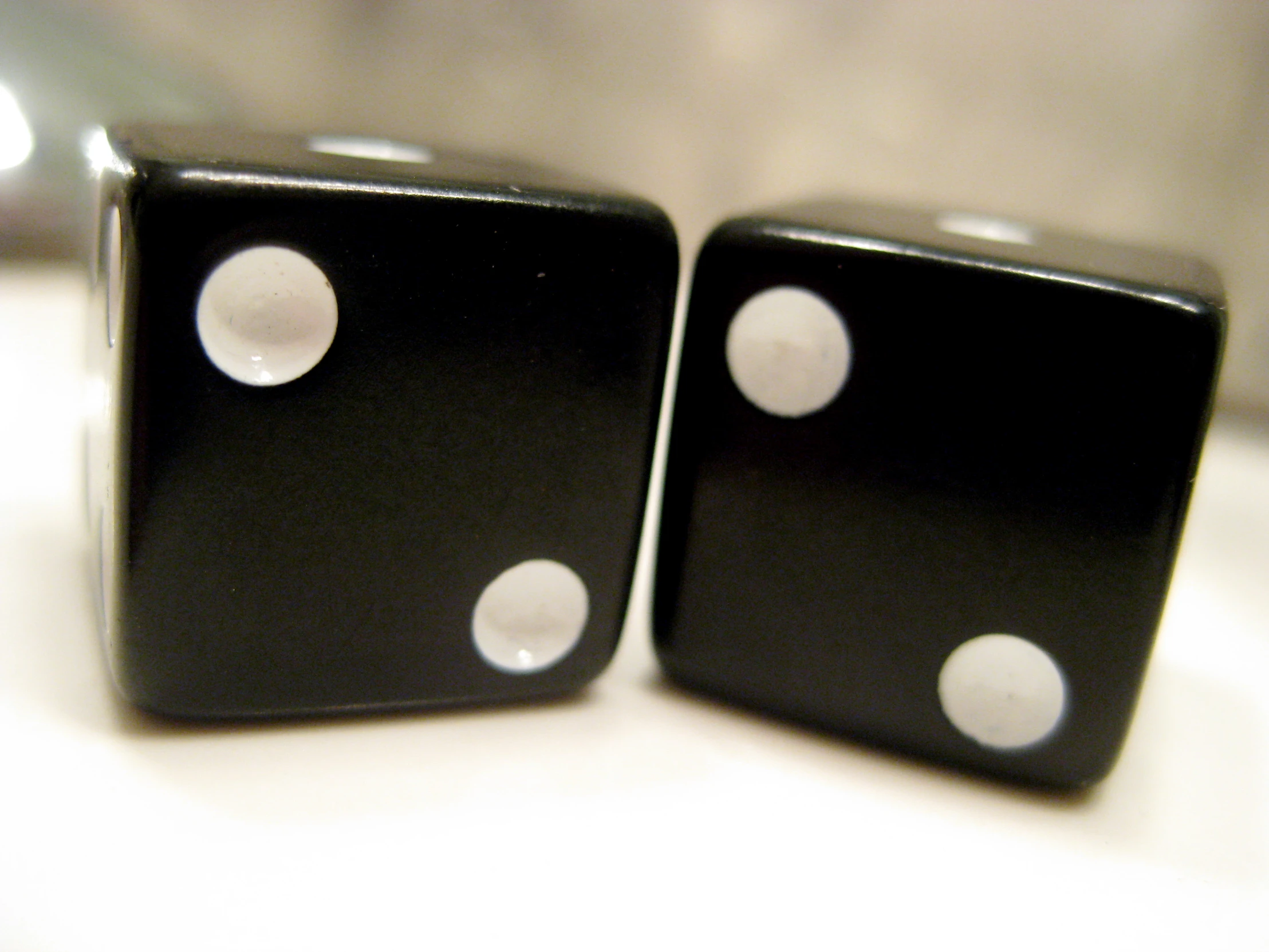 two black dices with one missing on top of each