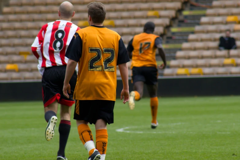 soccer players in yellow jerseys are playing soccer