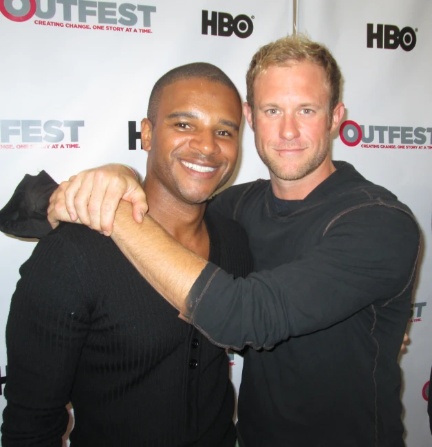 two men standing close together at an event