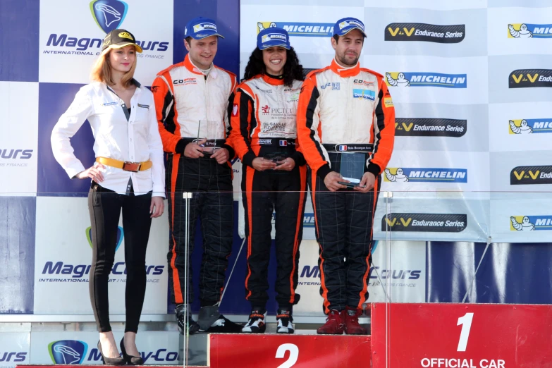 two females and a male on a podium