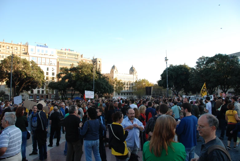 crowd of people gathered near building in urban setting