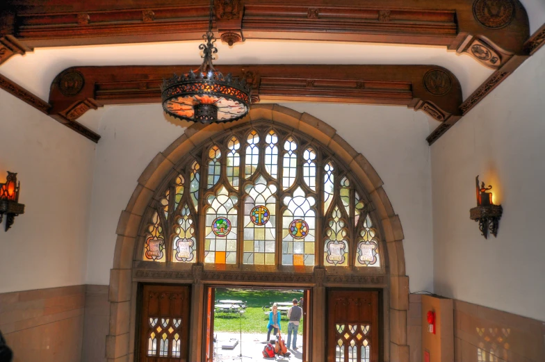 a doorway with a large glass window and a ceiling fan