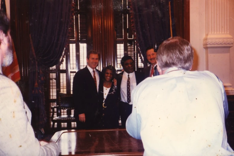 a group of business people are gathered in a building