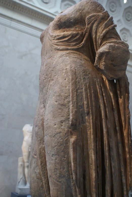 statue in front of marble sculptures of two heads