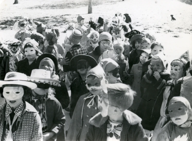 many children with faces are standing in the snow