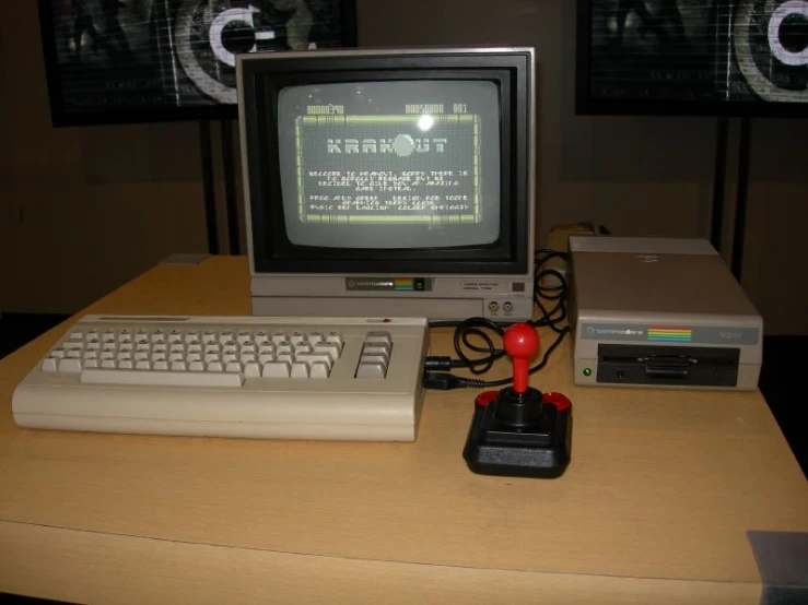 a laptop and computer on a table with a small monitor