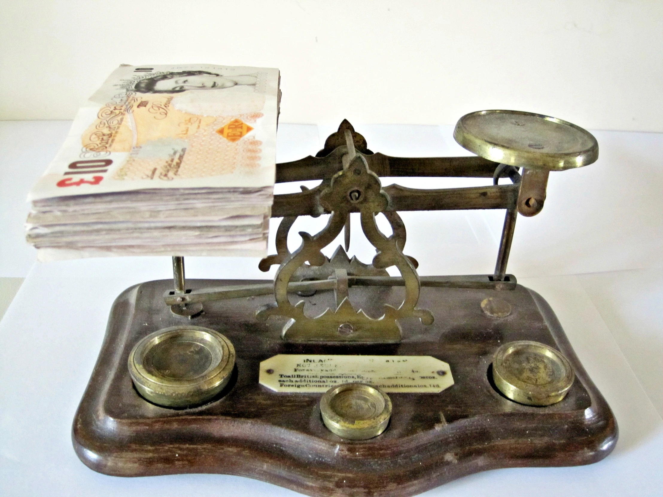 the clock is placed on the metal base with coins