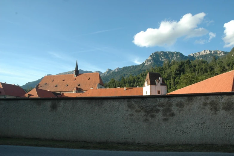 a tall building sitting under a mountain in the background