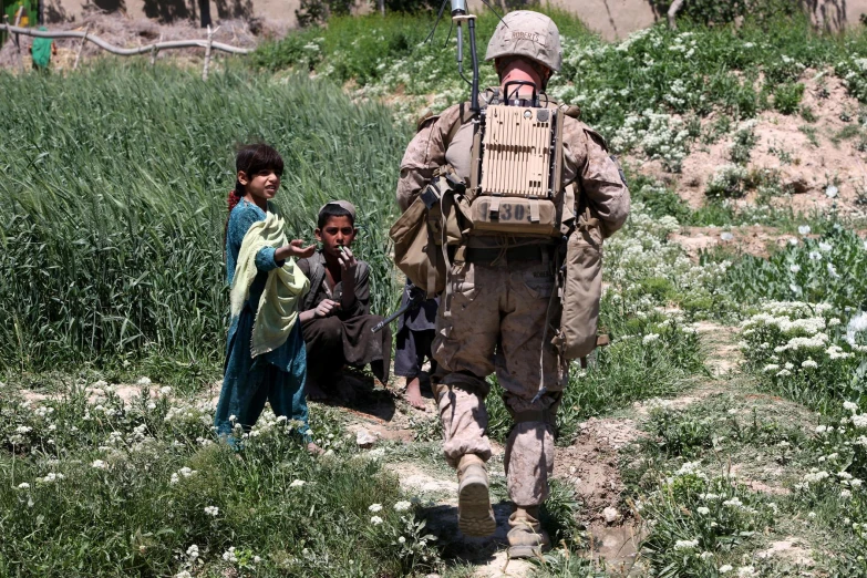 a couple of young children standing next to each other on a hill