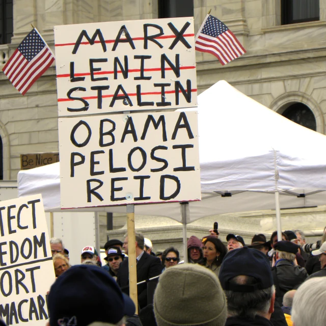 political protest signs on the street near an obama rally