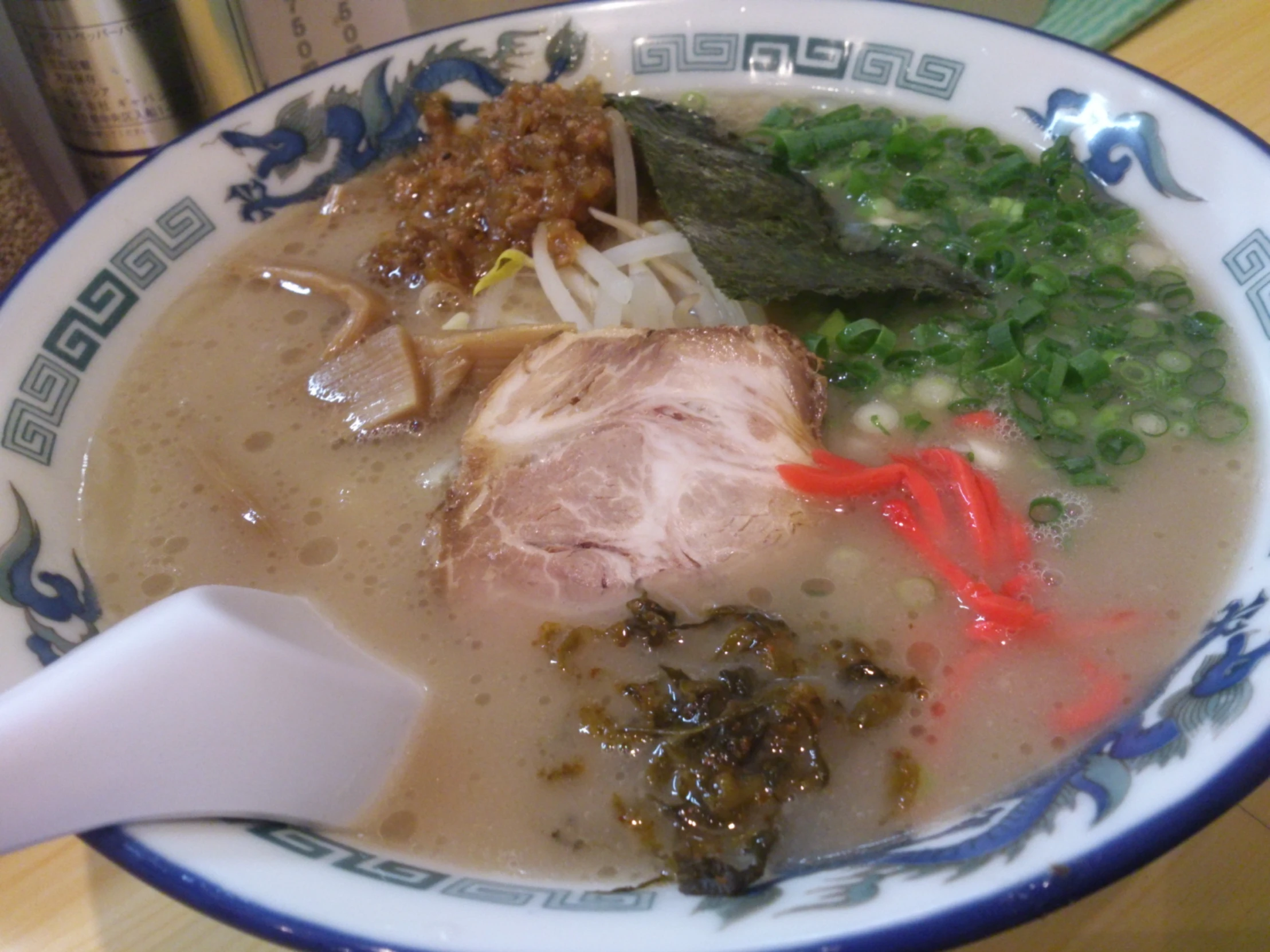 a bowl full of meat, rice and other vegetables