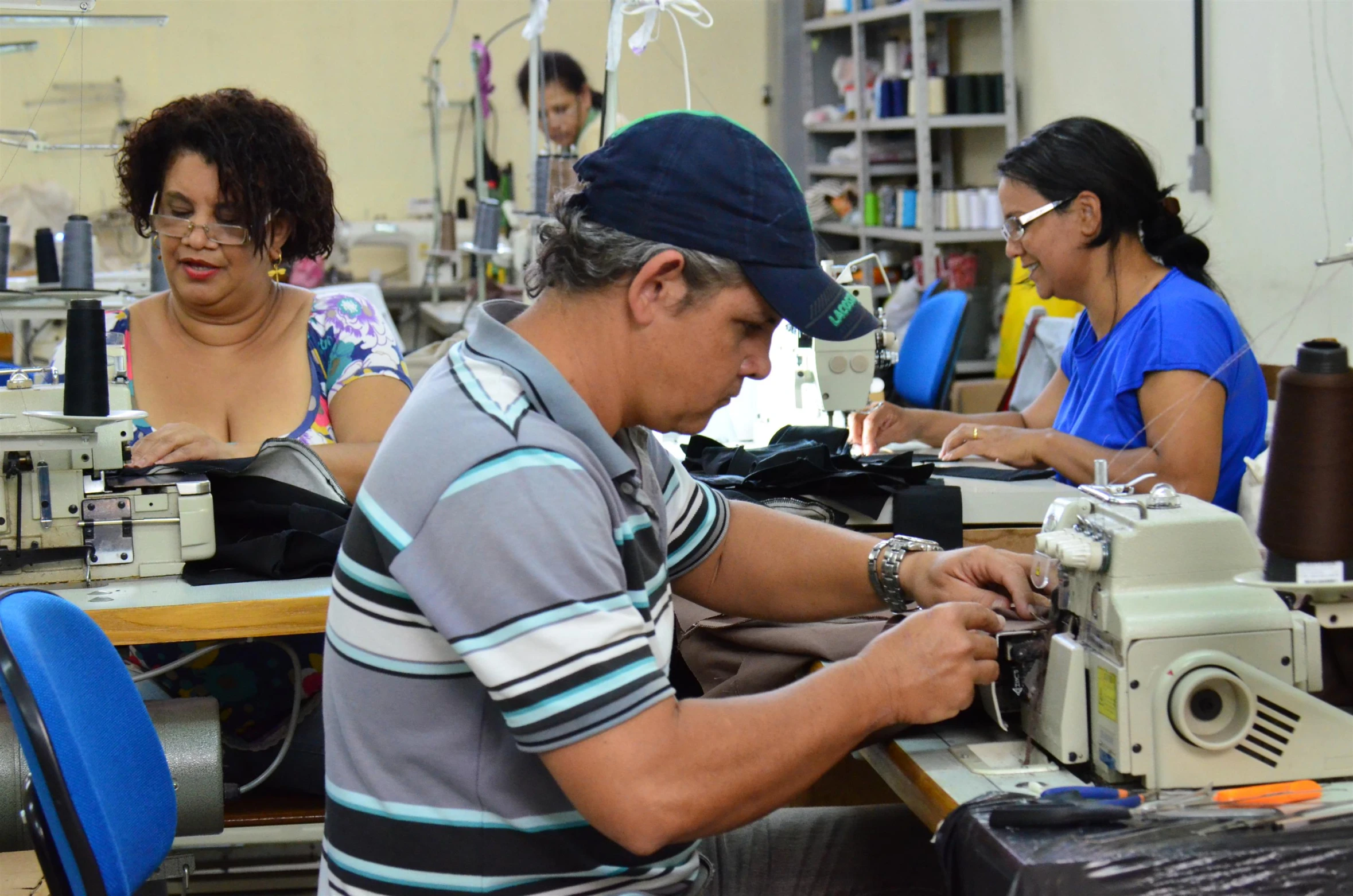 a man is working on a sewing machine