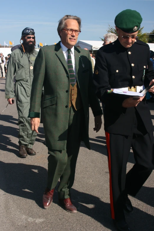 two men walking down the street in military dress uniforms