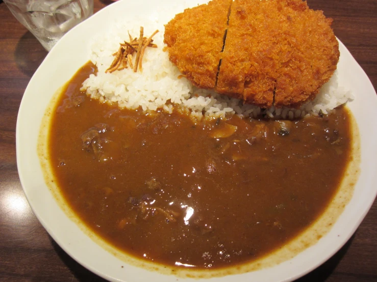 a dish with a fried piece of bread and rice